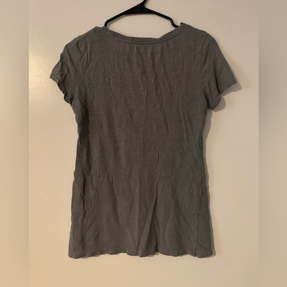 gray shirt with orange and white writting